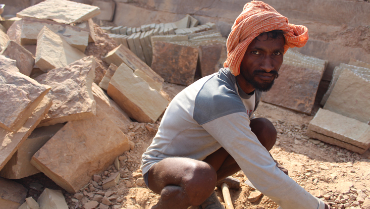 Photo of a man producing brickes